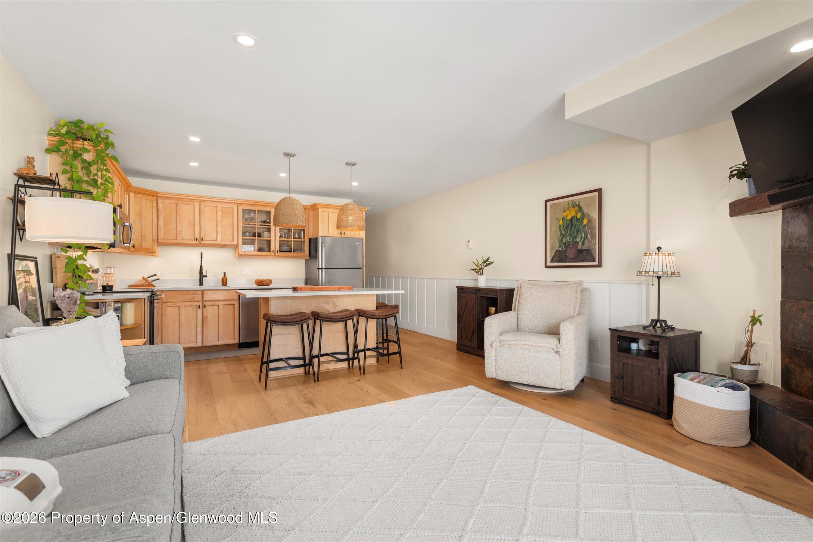 400 Wood Road, Unit D1206 Snowmass Village, CO 81615 - Photo 6 of 12 a living room with furniture and a flat screen tv