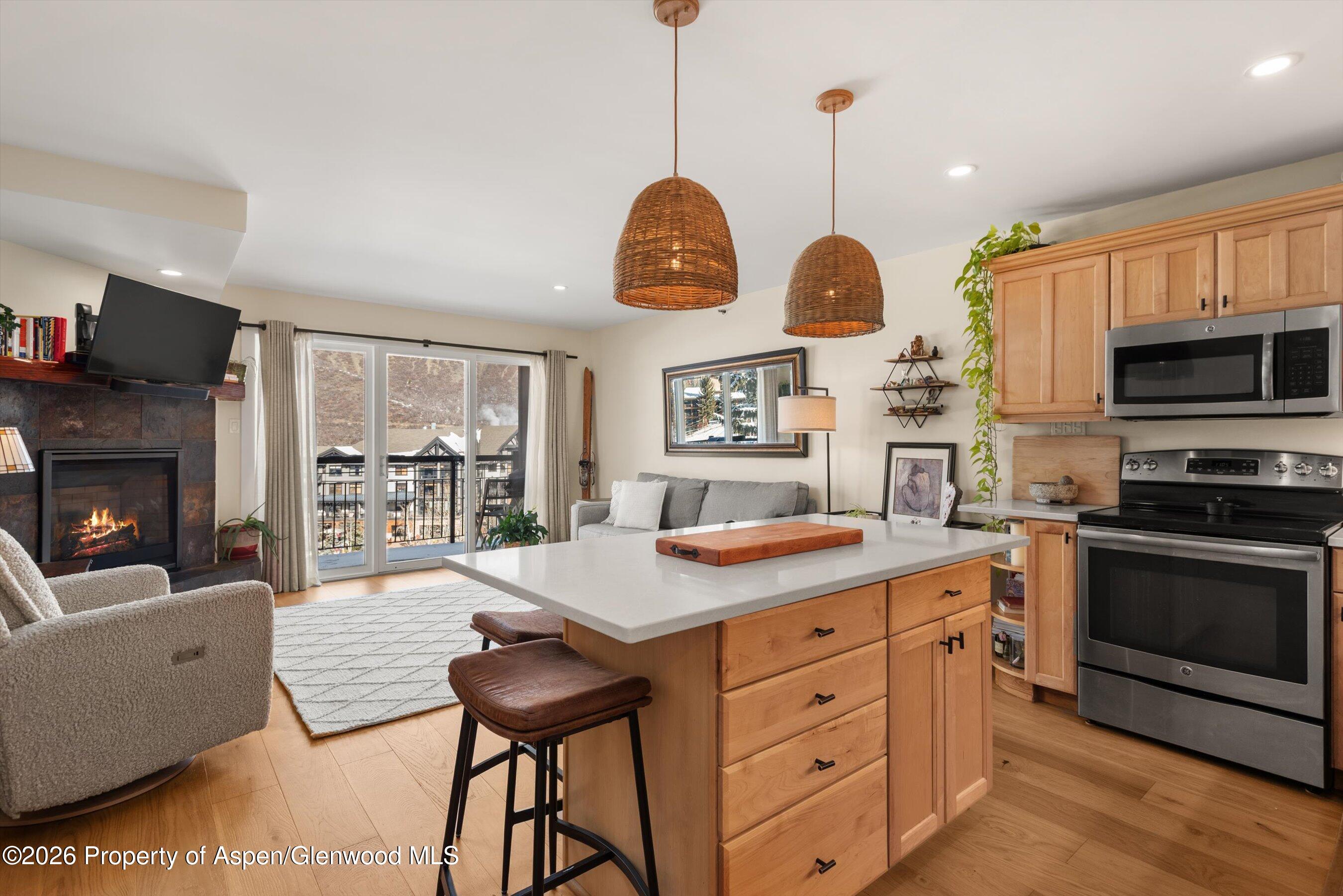 400 Wood Road, Unit D1206 Snowmass Village, CO 81615 - Photo 8 of 12 a view of kitchen with cabinets and flat screen tv