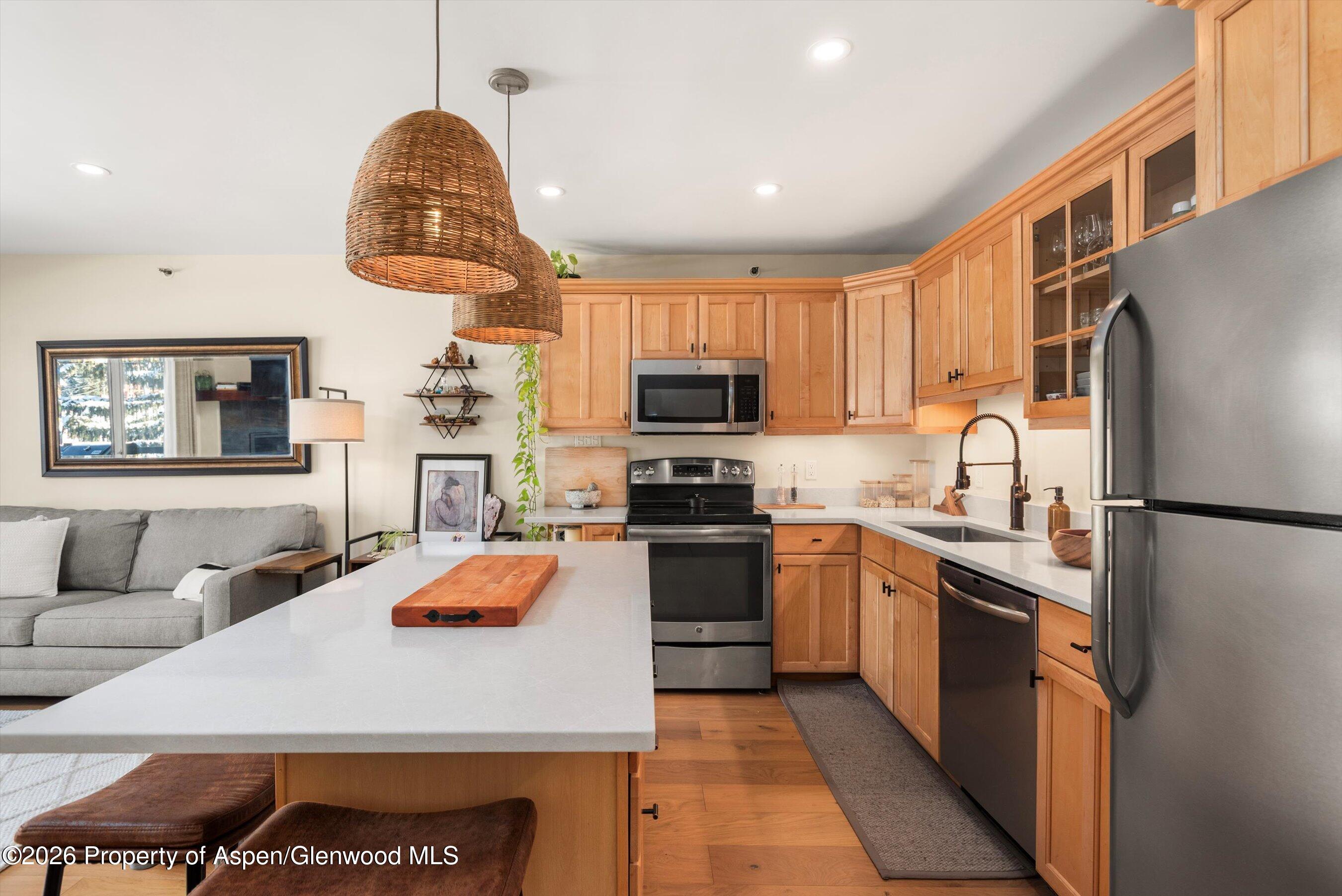 400 Wood Road, Unit D1206 Snowmass Village, CO 81615 - Photo 9 of 12 a kitchen with stainless steel appliances a stove a sink a microwave and a refrigerator