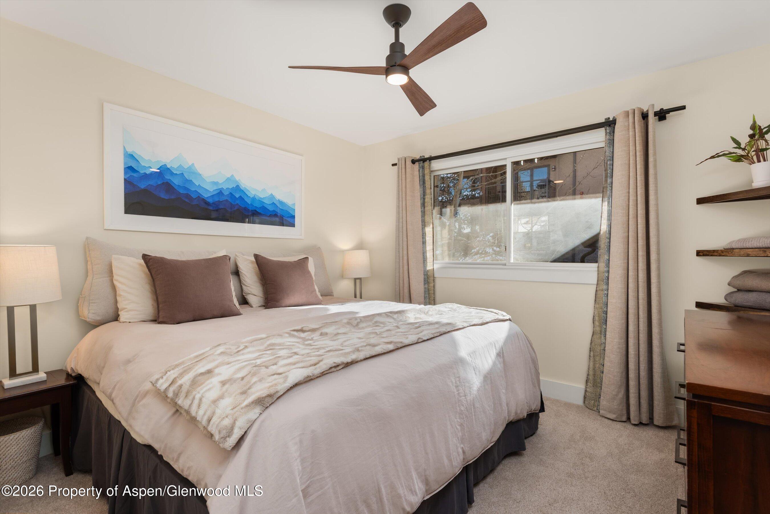 400 Wood Road, Unit D1206 Snowmass Village, CO 81615 - Photo 10 of 12 a bedroom with a bed and a painting on the wall