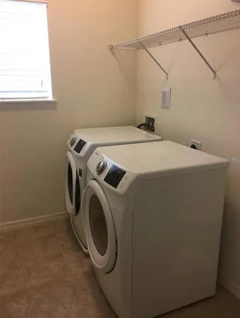 a bathroom with a granite countertop sink and a toilet