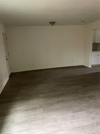 a view of room with wooden floor