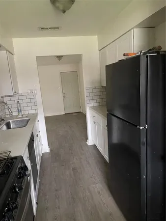 a kitchen with a refrigerator and a sink