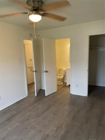 an empty room with a bathroom and a sink