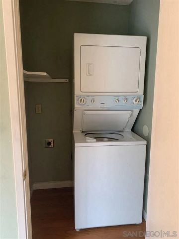 an empty room with a ceiling fan and a window