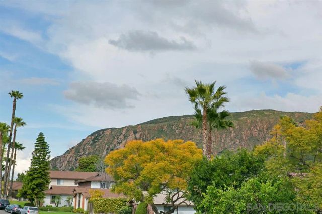 a street sign on a wall next to a road