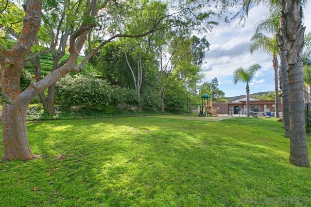 a view of a house with swimming pool and sitting area