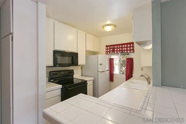 a view of a pathway with a wrought fence