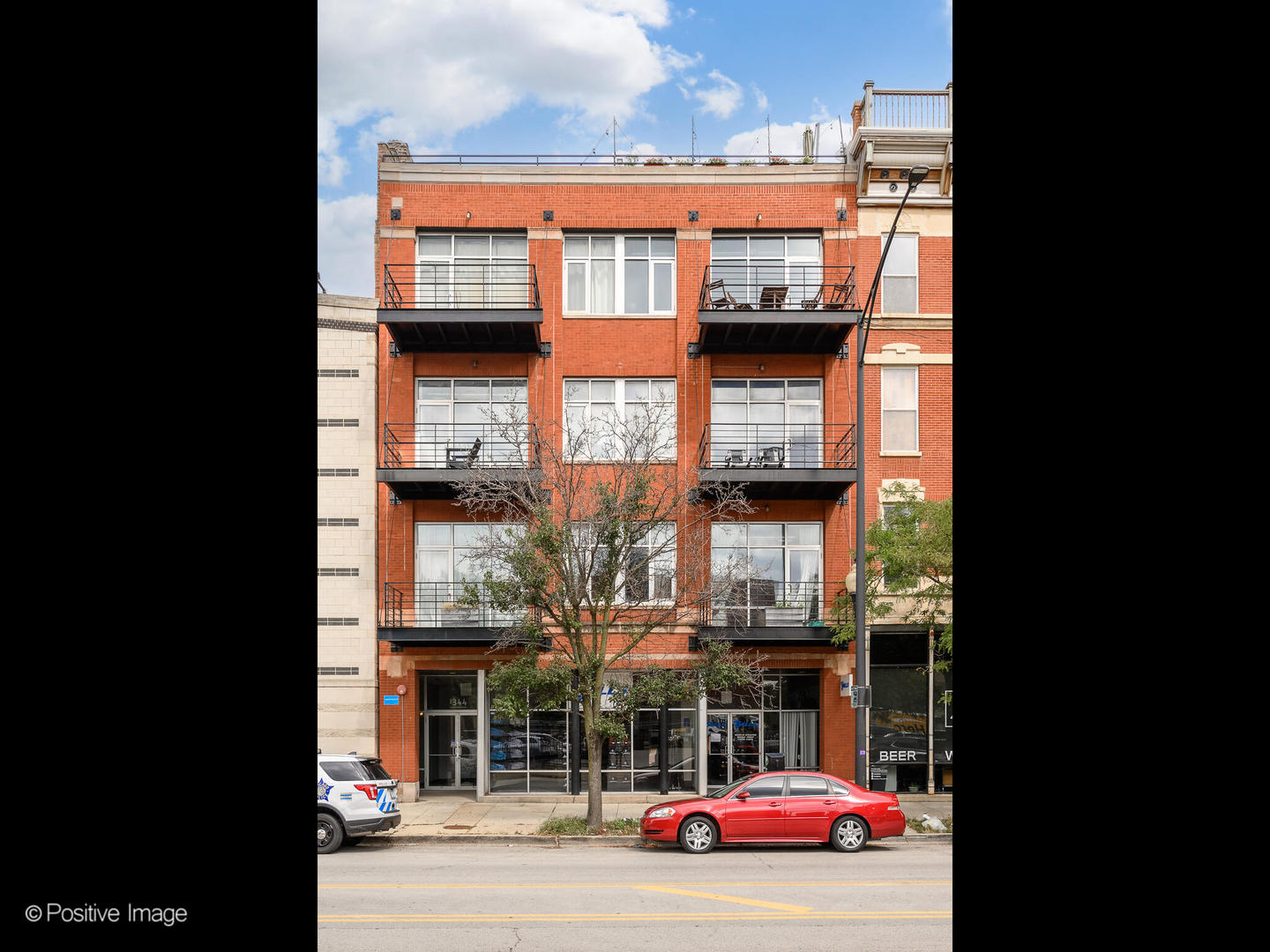 1344 West Madison Street, Unit 301 Chicago, IL 60607 - Photo 1 of 13 a front view of a building with glass windows and door