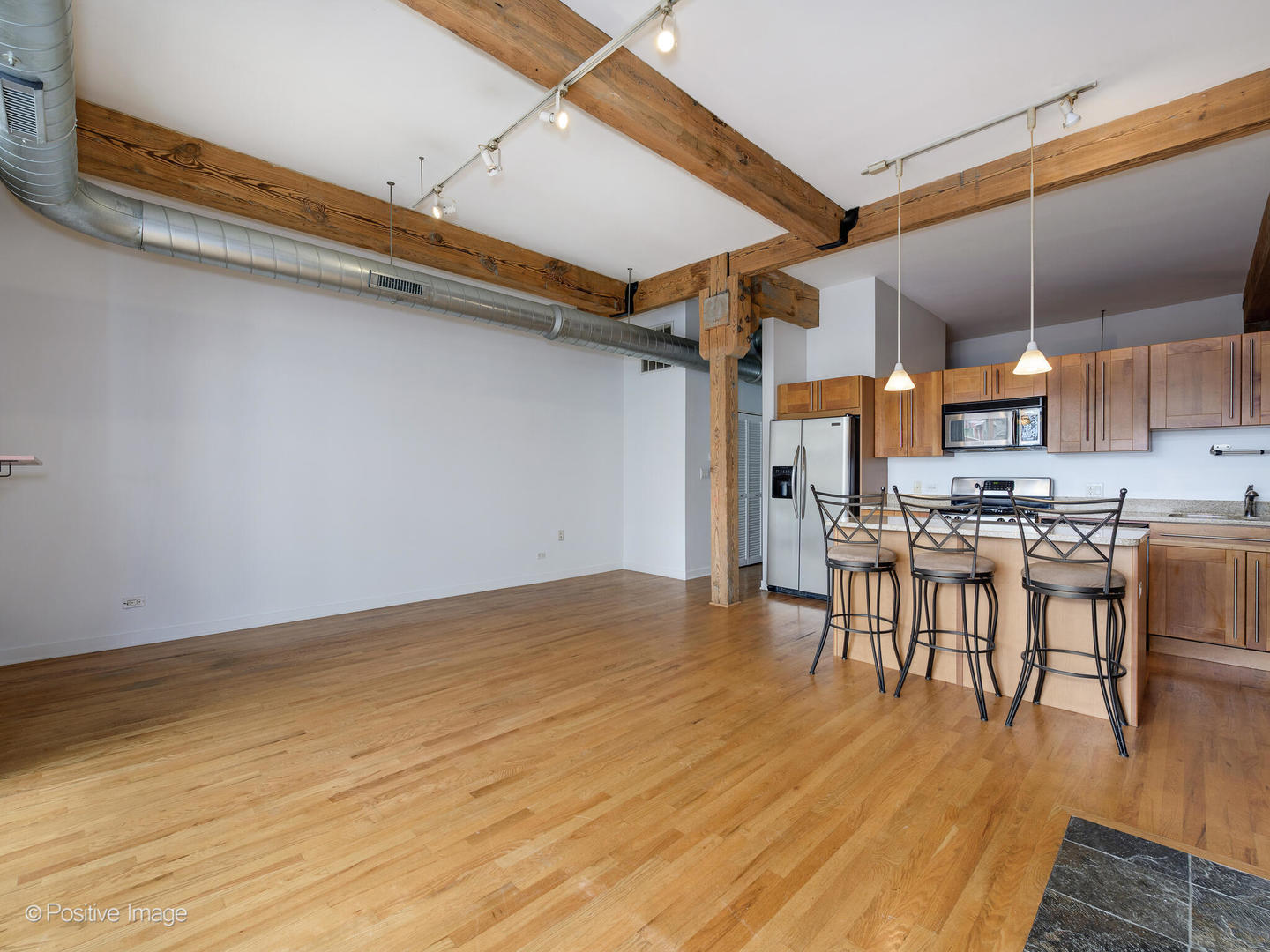 1344 West Madison Street, Unit 301 Chicago, IL 60607 - Photo 4 of 13 a view of kitchen and dining room with wooden floor