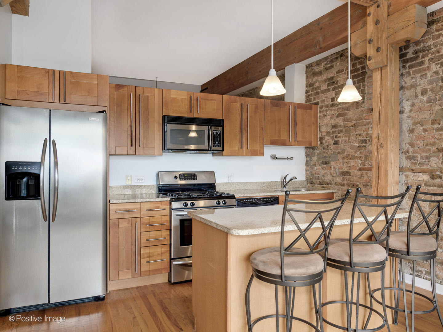 1344 West Madison Street, Unit 301 Chicago, IL 60607 - Photo 6 of 13 a kitchen with stainless steel appliances granite countertop a stove a sink a microwave and a refrigerator