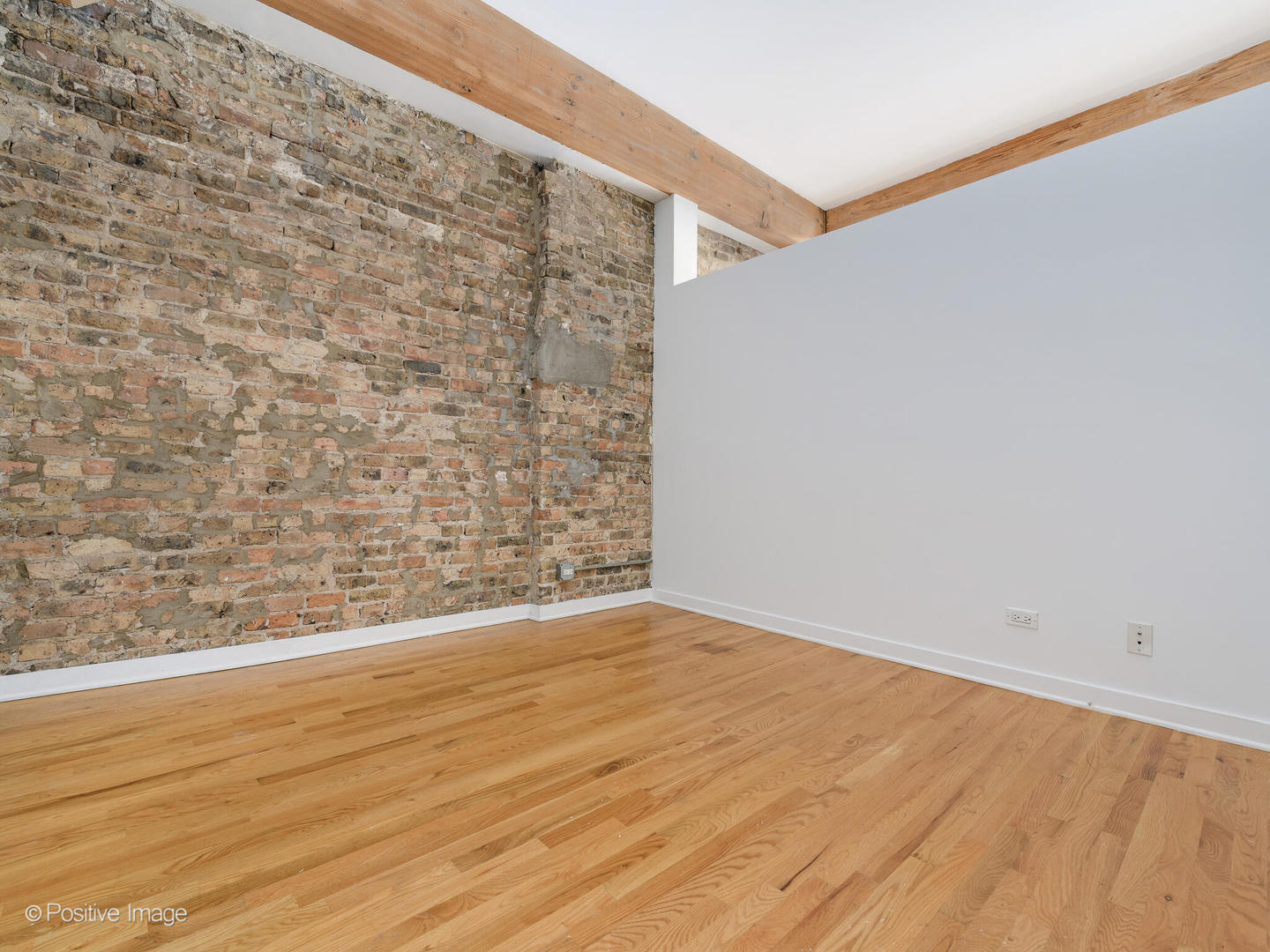 1344 West Madison Street, Unit 301 Chicago, IL 60607 - Photo 8 of 13 a view of an empty room and wooden floor