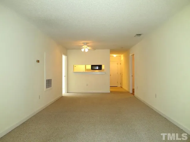 a view of a kitchen with a sink and a refrigerator