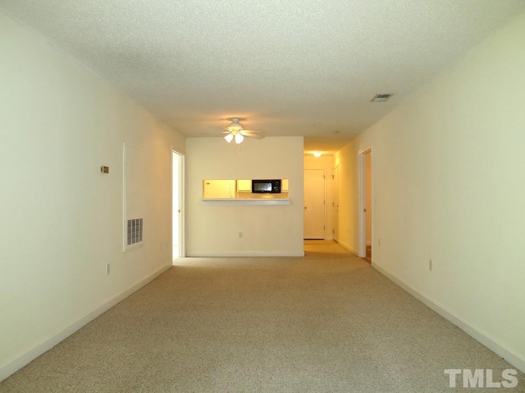 303 Smith Level Road, Unit F11 Chapel Hill, NC 27516 - Photo 4 of 14 a view of a kitchen with a sink and a refrigerator