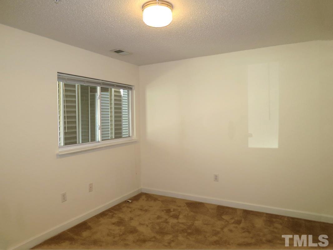 303 Smith Level Road, Unit F11 Chapel Hill, NC 27516 - Photo 6 of 14 an empty room with a window