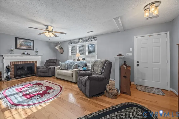 a living room with furniture a chandelier and a fireplace