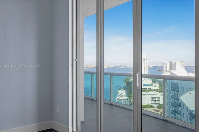 a view of a glass door and a yard from a window