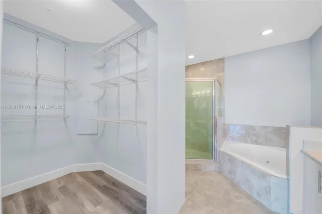 a bathroom with a bathtub and shower