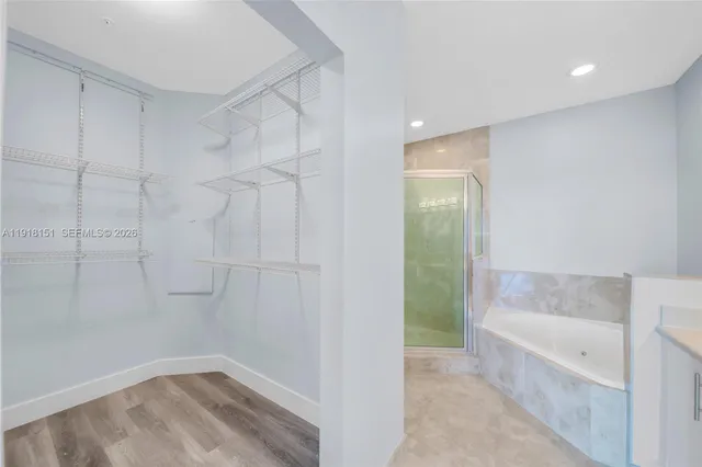 a bathroom with a shower sink vanity mirror and toilet