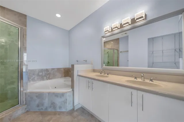 a bathroom with a sink a mirror and a bathtub