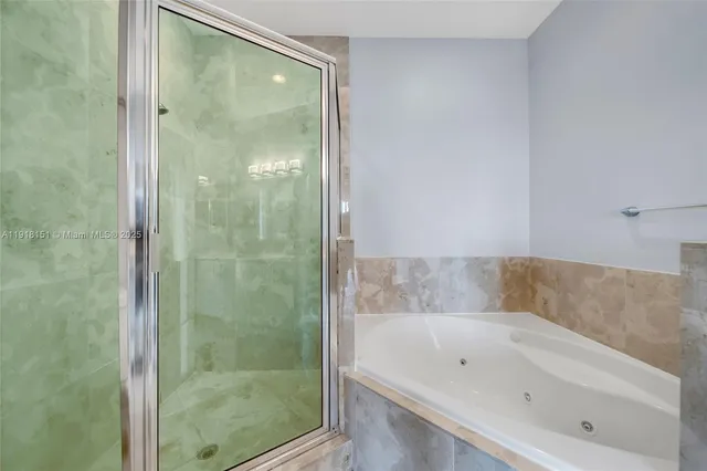 a bathroom with a bathtub and shower