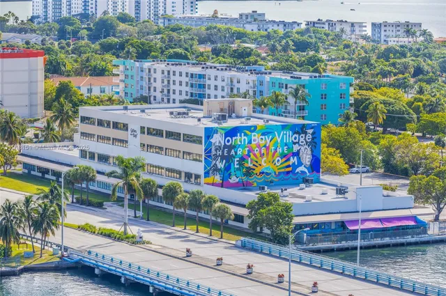a view of a building with a swimming pool and outdoor seating