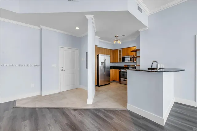 a view of kitchen view wooden floor and electronic appliances