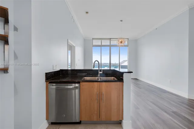 a kitchen with stainless steel appliances granite countertop a sink and a stove