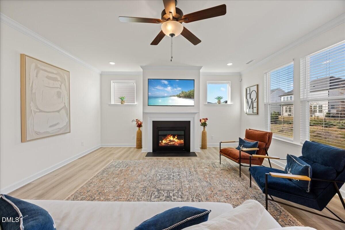 653 Craftsman Rdg Trail Knightdale, NC 27545 - Photo 9 of 50 a living room with furniture a fireplace and a flat screen tv