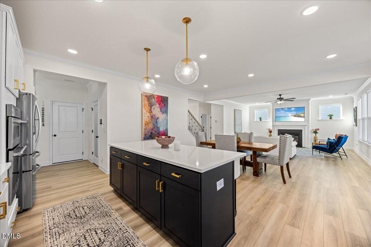 653 Craftsman Rdg Trail Knightdale, NC 27545 - Photo 48 of 50 a living room with stainless steel appliances granite countertop furniture wooden floor and a view of living room
