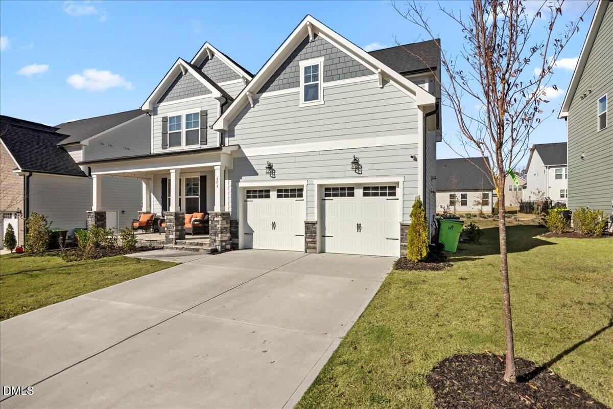 653 Craftsman Rdg Trail Knightdale, NC 27545 - Photo 2 of 50 a front view of a house with a yard and garage