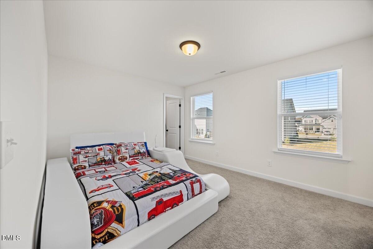 653 Craftsman Rdg Trail Knightdale, NC 27545 - Photo 31 of 50 a bedroom with a bed and a window