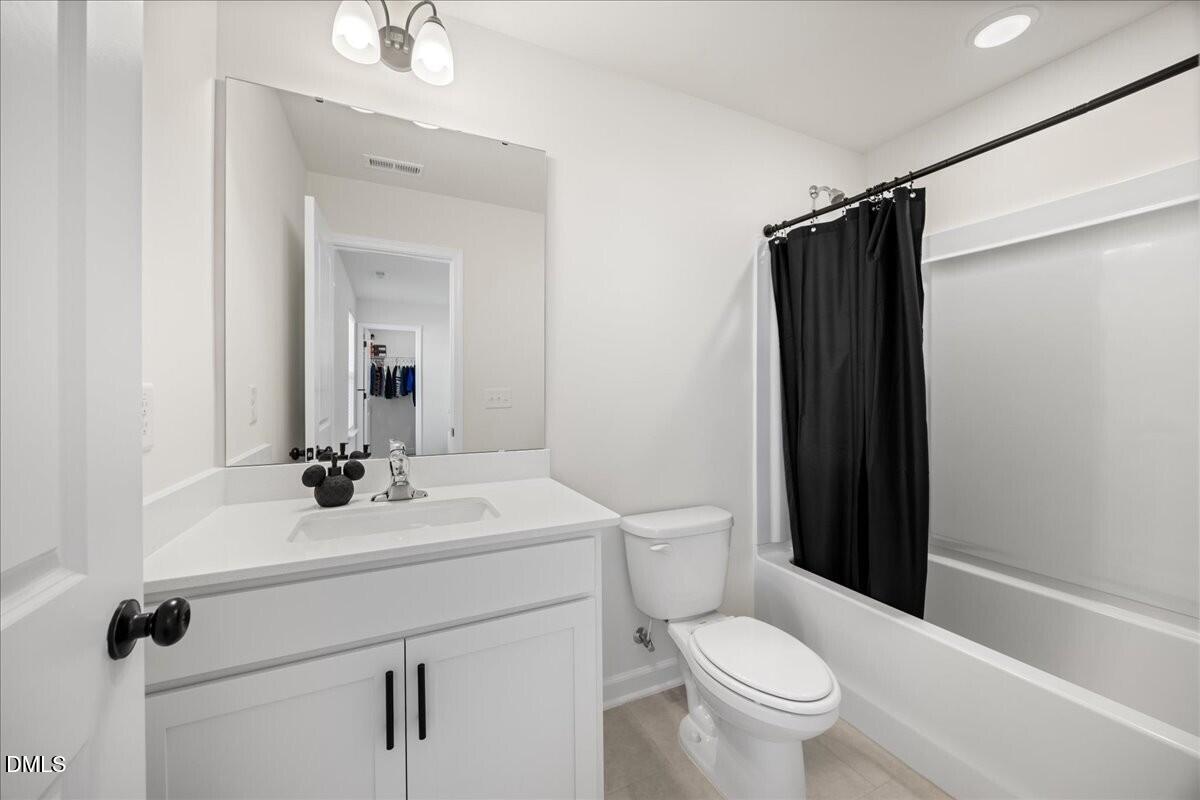 653 Craftsman Rdg Trail Knightdale, NC 27545 - Photo 32 of 50 a bathroom with a sink toilet and shower