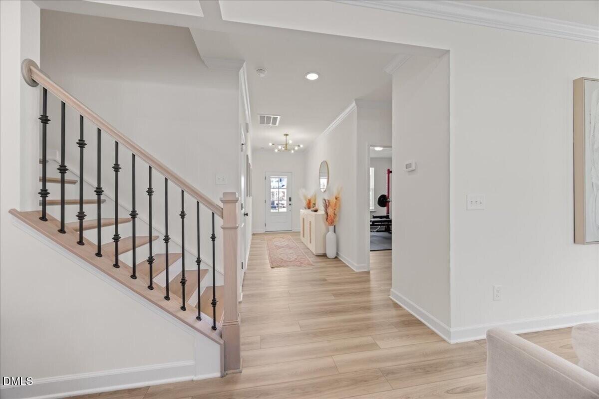 653 Craftsman Rdg Trail Knightdale, NC 27545 - Photo 5 of 50 a view of a hallway with wooden floor and staircase