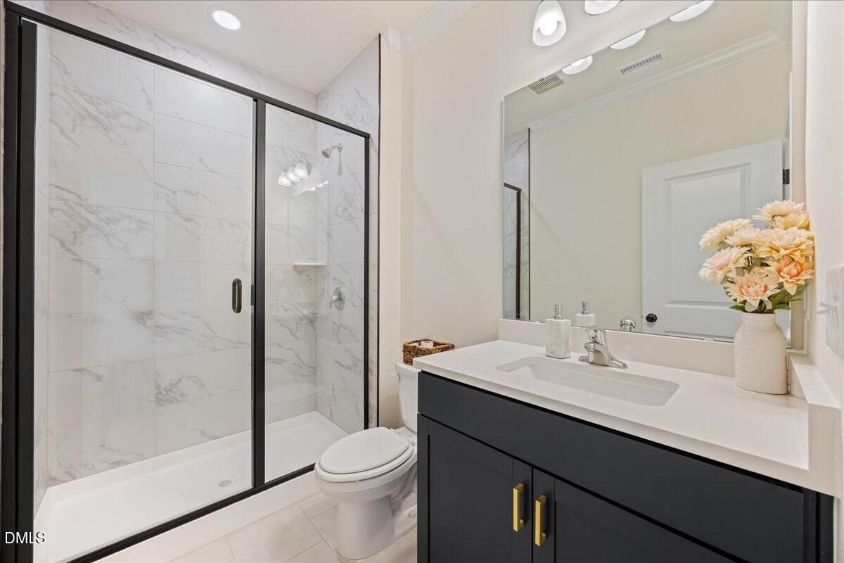 653 Craftsman Rdg Trail Knightdale, NC 27545 - Photo 6 of 50 a bathroom with a sink a toilet and shower