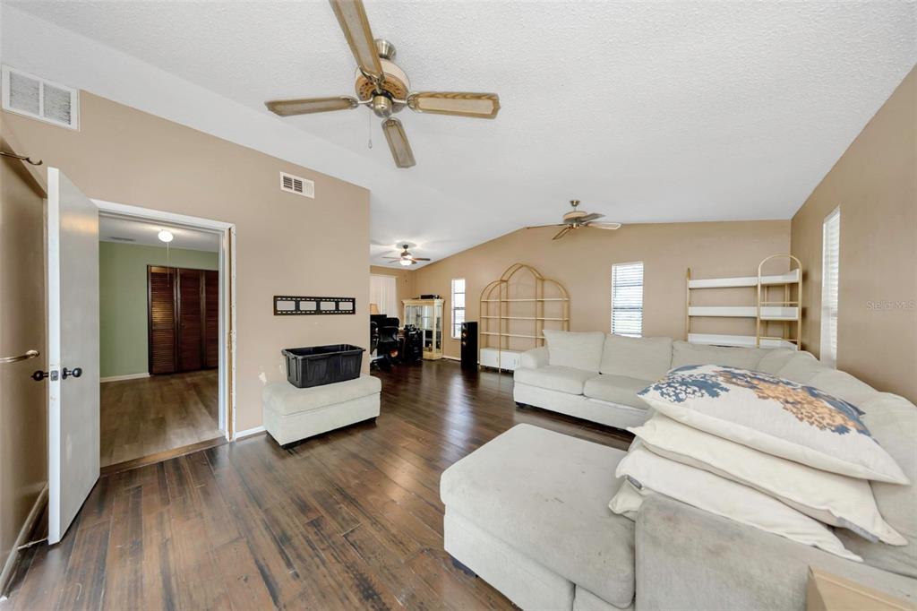 17704 Rivendel Road Lutz, FL 33549 - Photo 11 of 21 a bedroom with furniture and a wooden floor