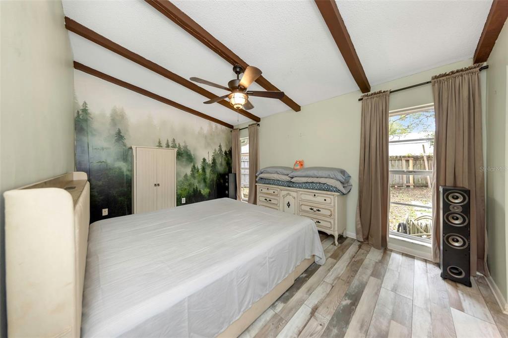17704 Rivendel Road Lutz, FL 33549 - Photo 13 of 21 a bedroom with a bed and a dresser next to a window