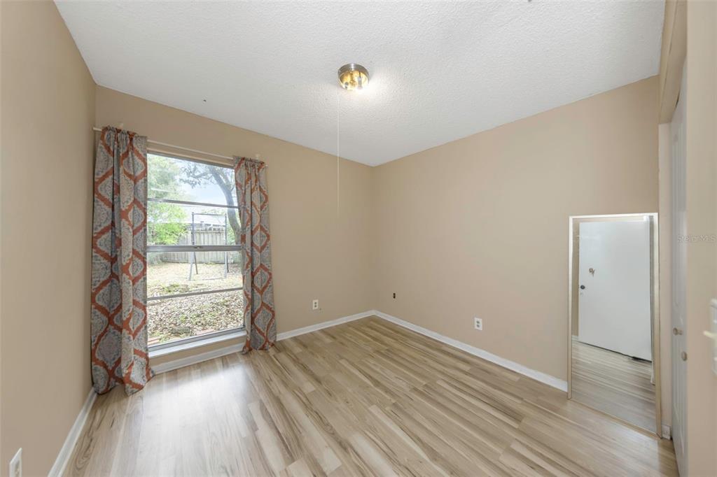 17704 Rivendel Road Lutz, FL 33549 - Photo 15 of 21 wooden floor in an empty room with a window