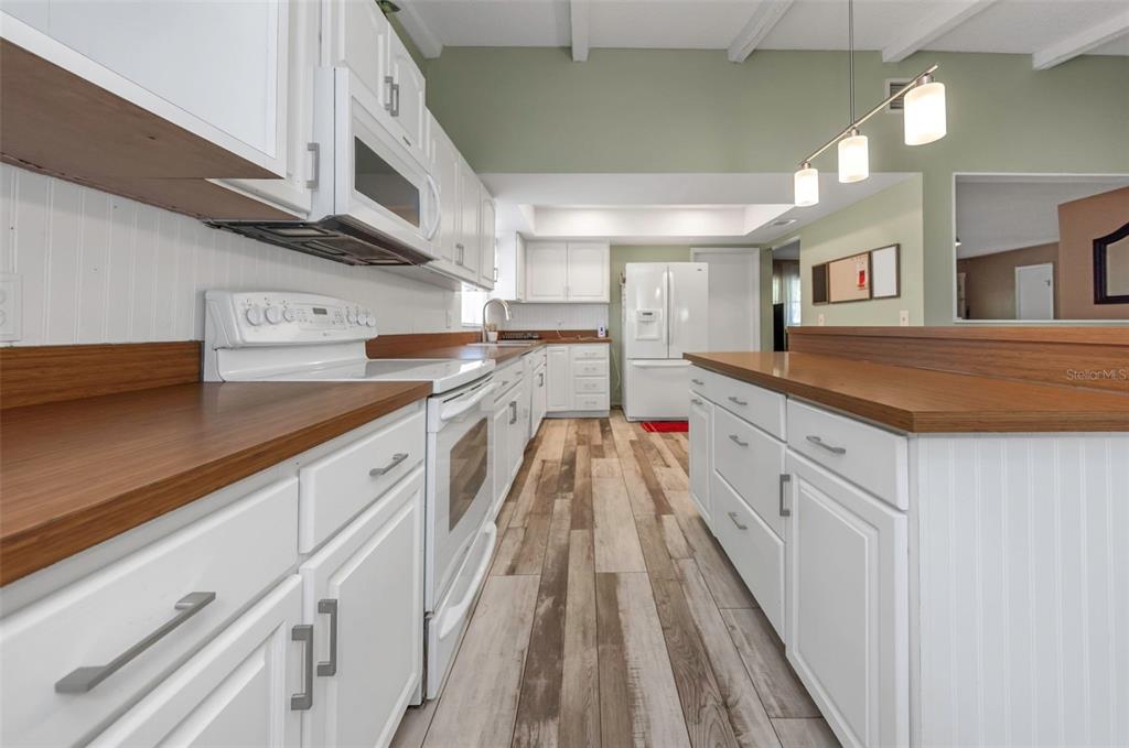17704 Rivendel Road Lutz, FL 33549 - Photo 4 of 21 a kitchen with cabinets and wooden floor