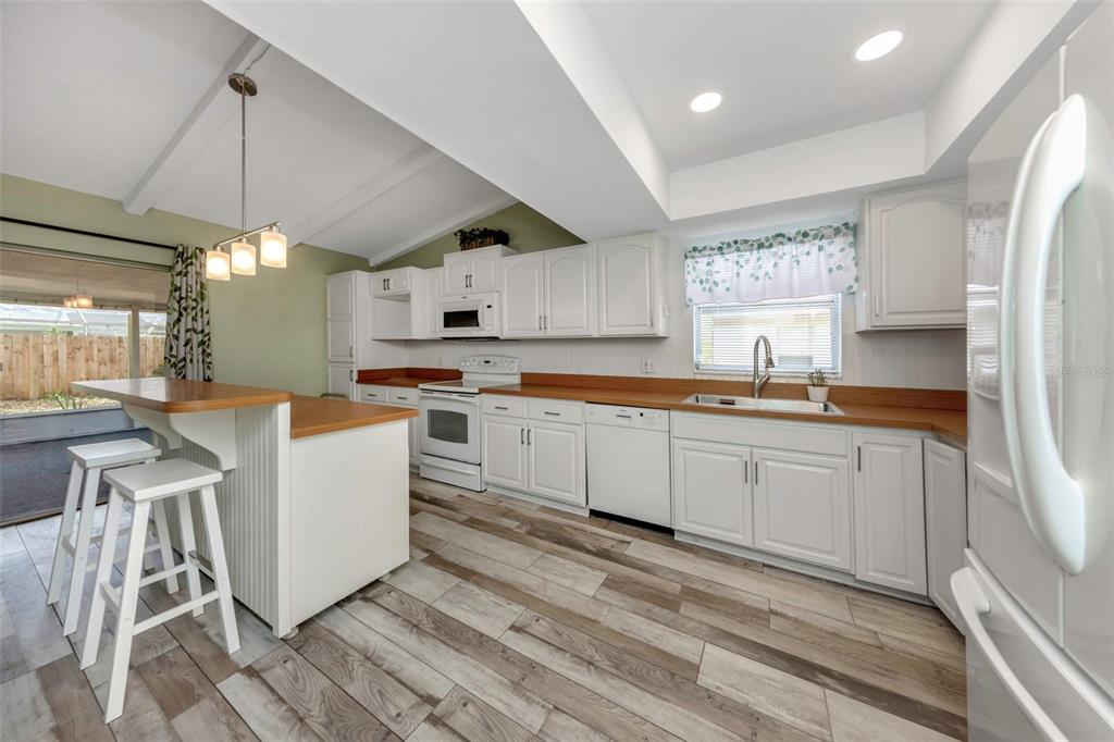 17704 Rivendel Road Lutz, FL 33549 - Photo 5 of 21 a kitchen with stainless steel appliances granite countertop a stove a sink dishwasher and a refrigerator
