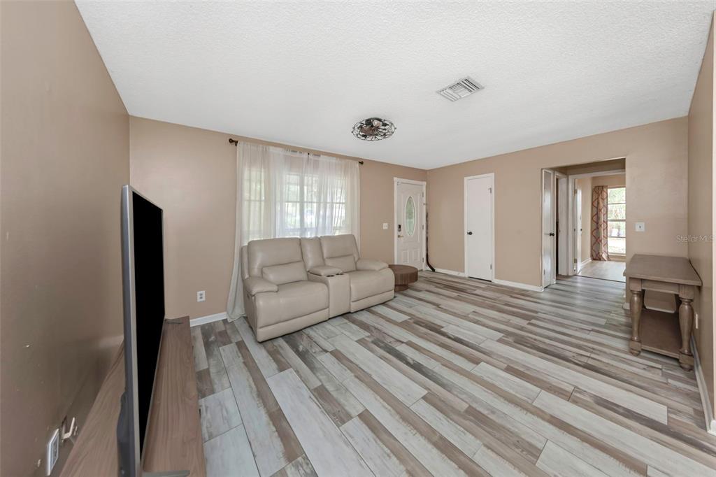 17704 Rivendel Road Lutz, FL 33549 - Photo 8 of 21 a living room with furniture and a wooden floor