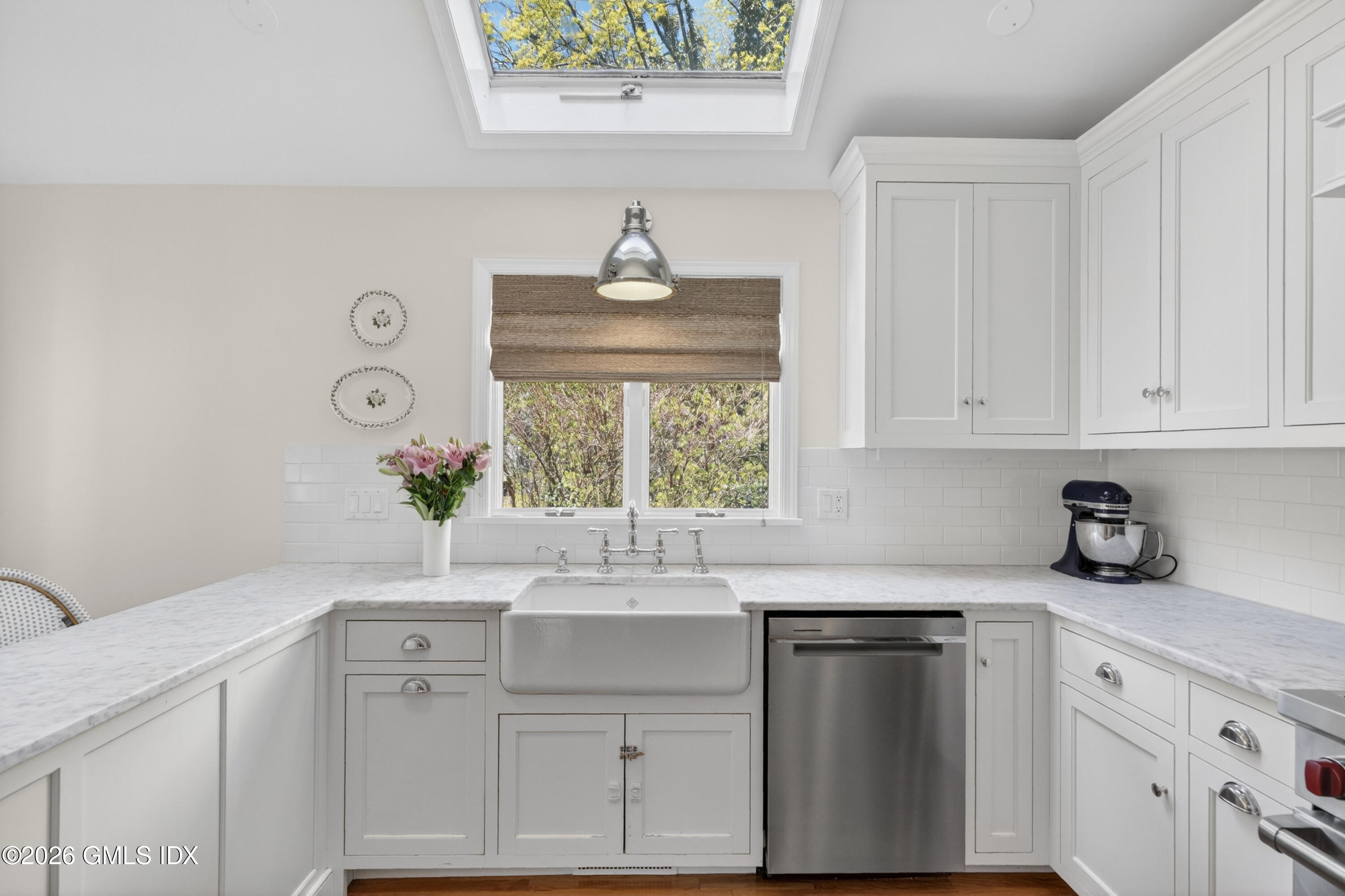 20 Ridge Road Cos Cob, CT 06807 - Photo 16 of 36 a kitchen with white cabinets and a window