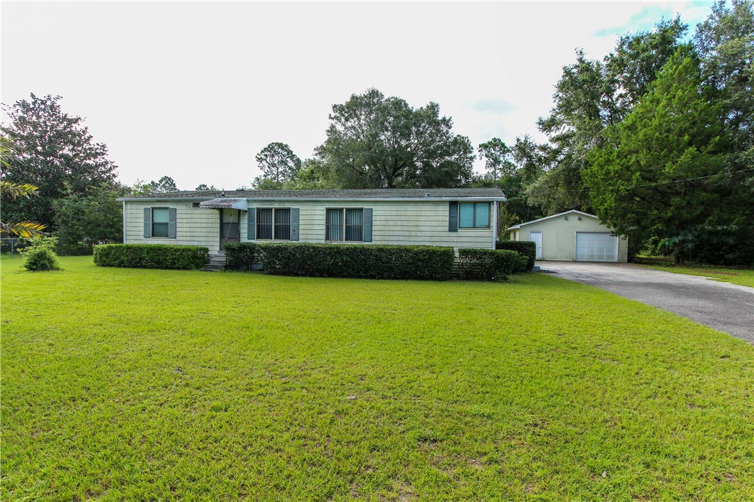 a front view of house with yard and outdoor seating