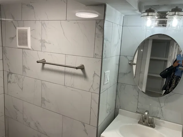 a bathroom with a sink and mirror