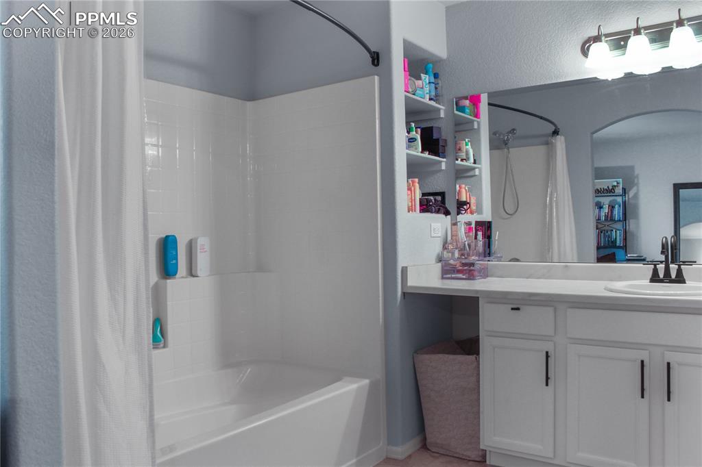 7649 Grand Fir Point Colorado Springs, CO 80908 - Photo 11 of 19 a bathroom with a bathtub sink vanity and mirror