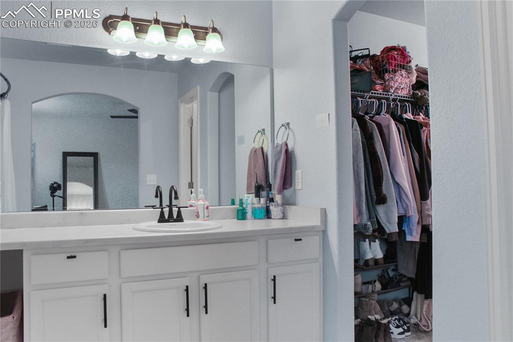 7649 Grand Fir Point Colorado Springs, CO 80908 - Photo 12 of 19 a bathroom with a sink and a mirror