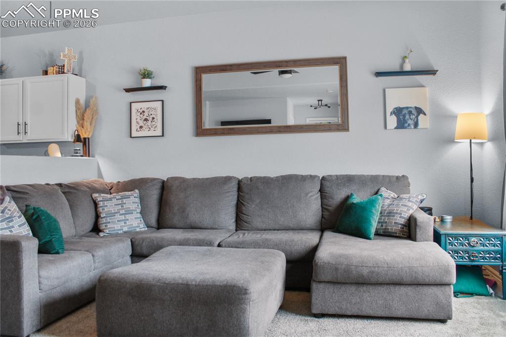 7649 Grand Fir Point Colorado Springs, CO 80908 - Photo 6 of 19 a living room with furniture and a couch