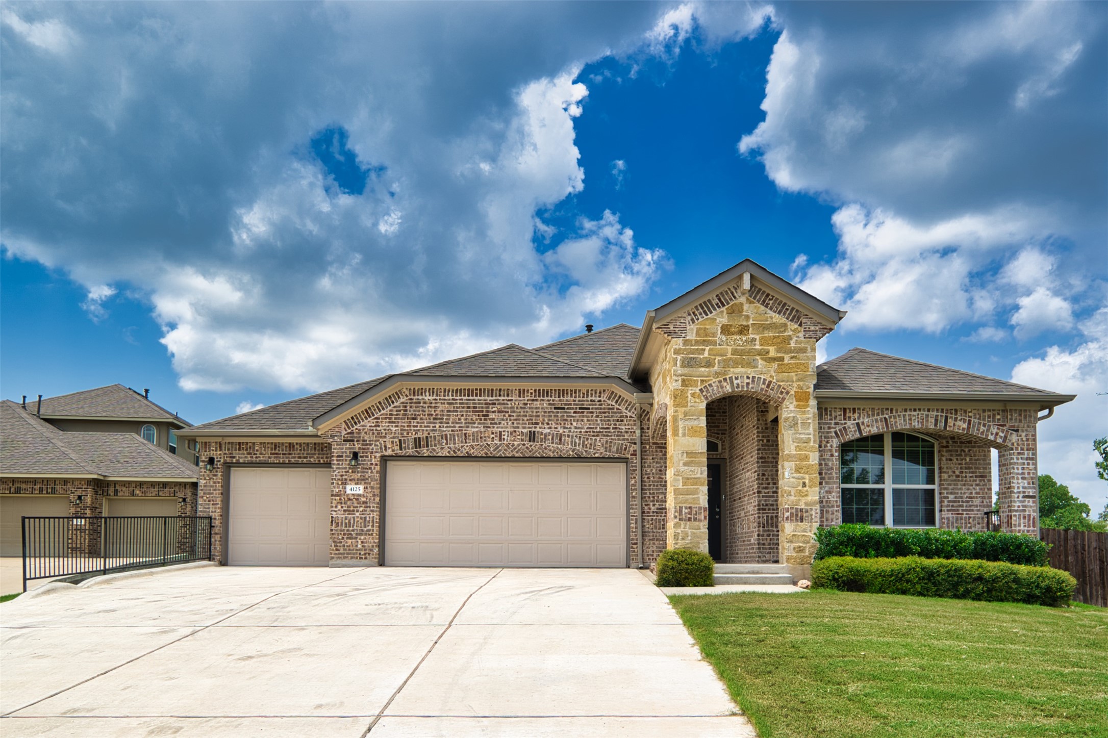 4125 Buffalo Ford Road Georgetown, TX 78628 - Photo 2 of 28 French country style house with roof with shingles, brick siding, and an attached garage
