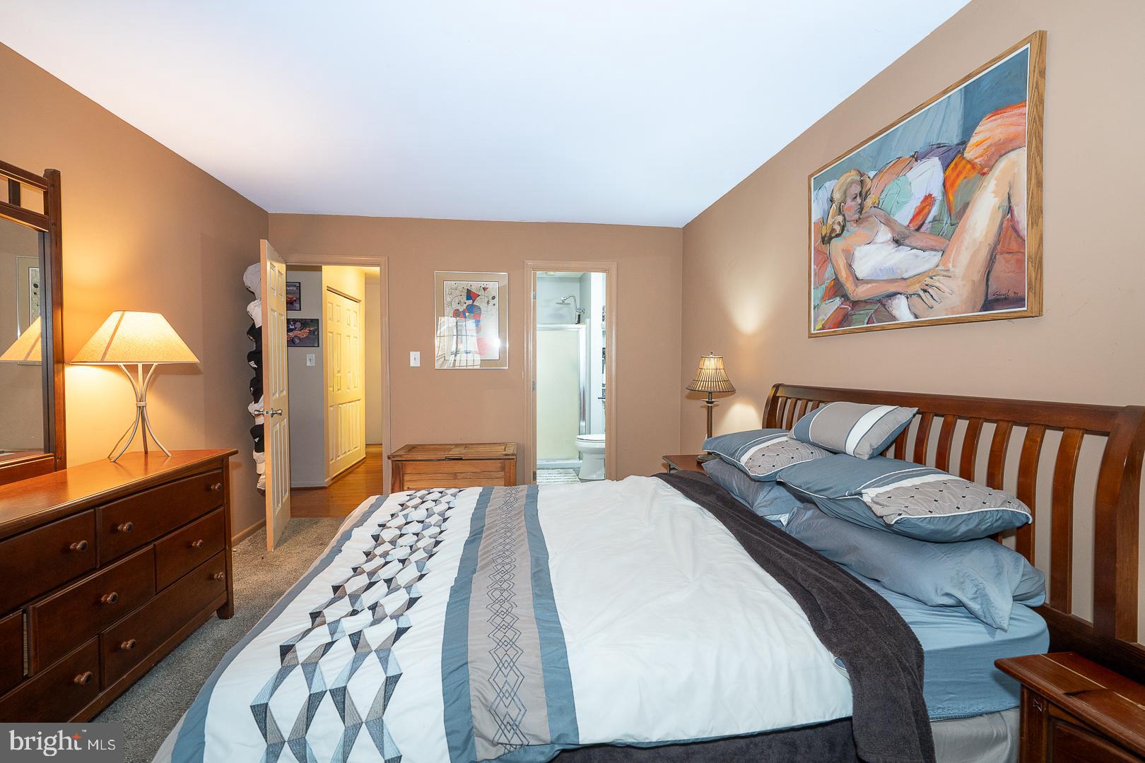108 Valley Stream Circle, Unit 108A Chesterbrook, PA 19087 - Photo 14 of 22 a bedroom with a bed and dresser with mirror