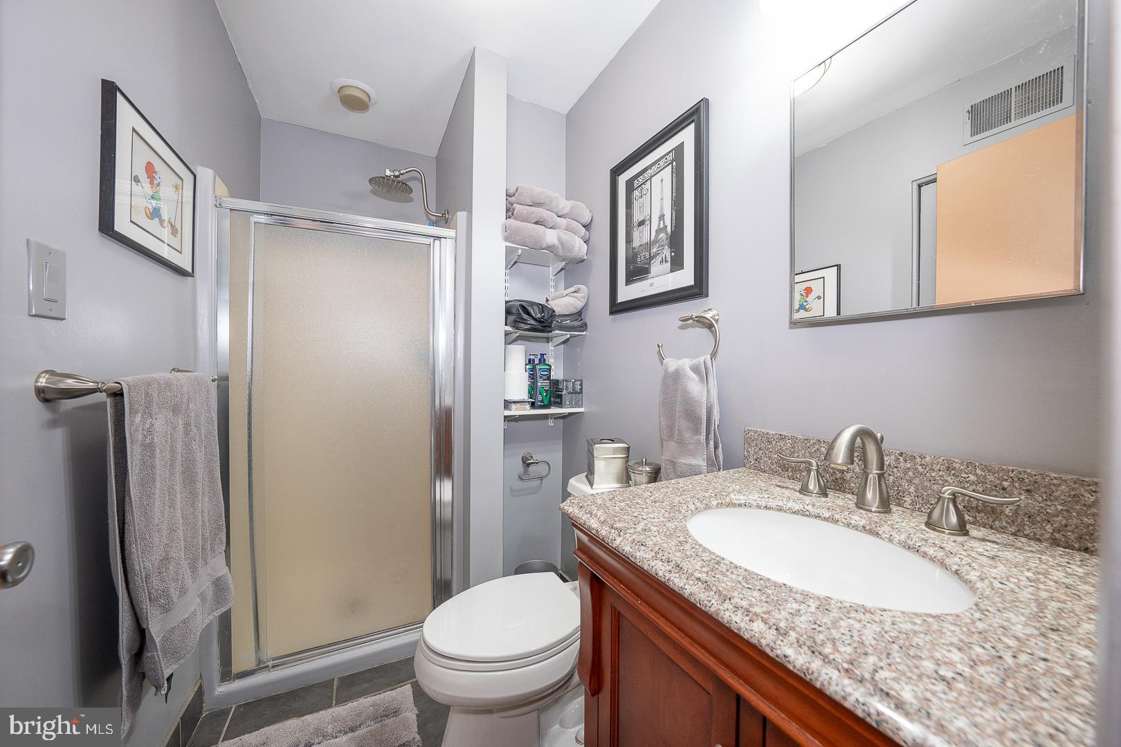 108 Valley Stream Circle, Unit 108A Chesterbrook, PA 19087 - Photo 15 of 22 a bathroom with a granite countertop sink toilet and shower